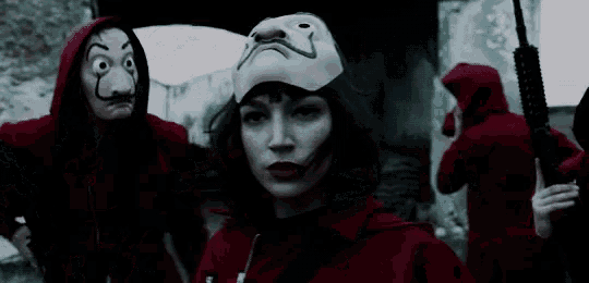 a woman wearing a mask and a hat is standing next to a man wearing a mask .