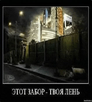a picture of a city street at night with a fence in the foreground and a building in the background .