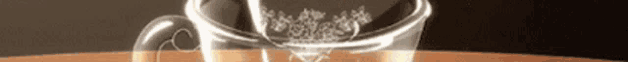 a close up of a glass on a table with smoke coming out of it