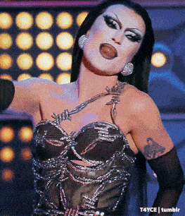 a woman with a tattoo on her arm is wearing a black top