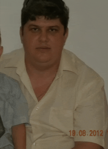a man in a white shirt has a photo taken on august 19 2012