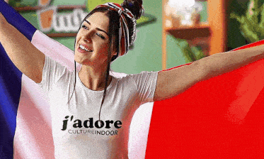 a woman wearing a t-shirt that says j'adore cultureindoor holds a french flag