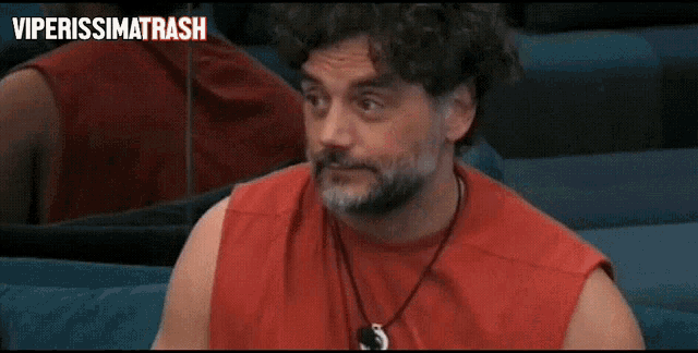 a man in a red tank top is holding a cup of coffee with the words viperissimarash above him