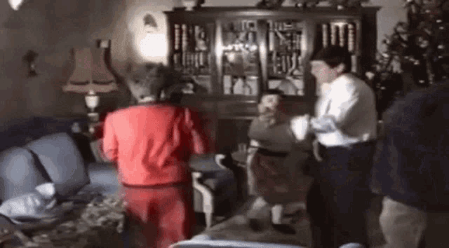 a group of people are dancing together in a living room