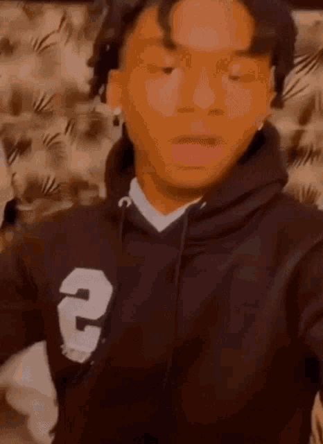 a young man is wearing a black hoodie and taking a selfie .