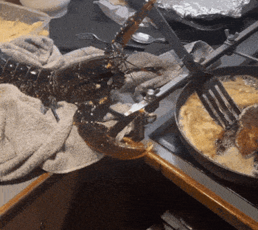 a lobster is being cooked in a frying pan on a counter