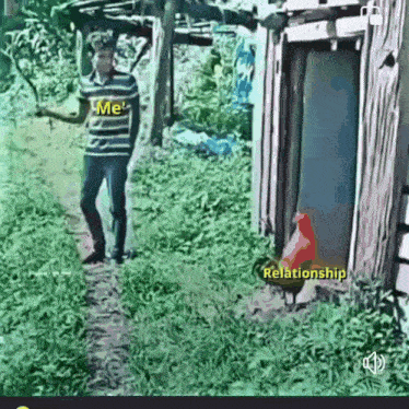 a man in a striped shirt is standing next to a chicken in a yard .