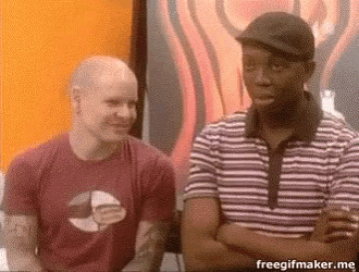 two men are sitting next to each other with their arms crossed in front of a painting .