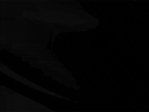 a close up of a black cloth moving in the wind on a black background .