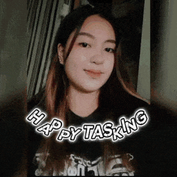 a young woman is smiling and wearing a black shirt with the words `` happy tasking '' on it .