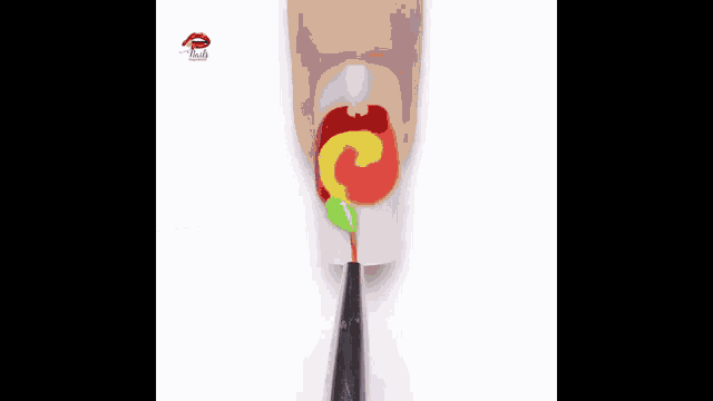 a close up of a person 's nails being painted in rainbow colors with a brush .