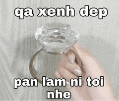 a person is holding a diamond ring in their hand