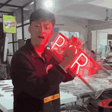 a man holding a sign that says p and r on it