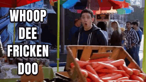 a man is standing in front of a box of carrots with the words whoop dee fricken doo written on it
