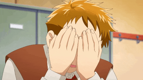 a man covering his face with his hands in front of a locker