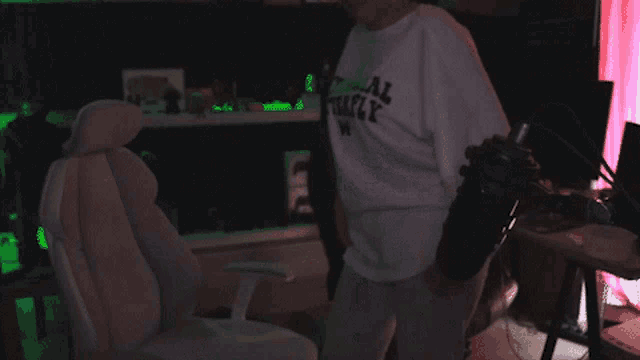 a person wearing a white shirt that says total freaky