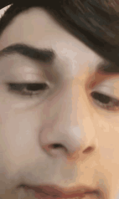a close up of a man 's face with his eyes closed and his mouth open .