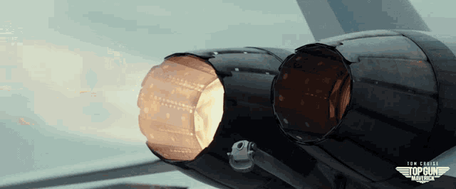 a close up of a jet engine with the words top gun on the bottom