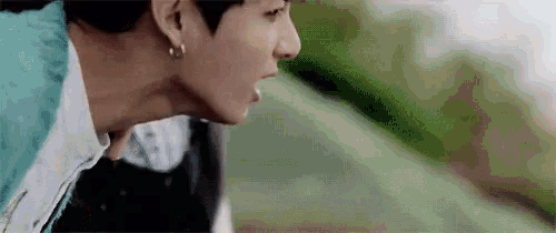 a close up of a man 's face with his mouth open .