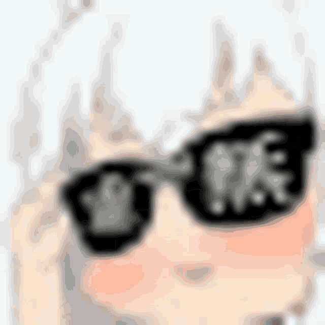 a blurred image of a girl wearing sunglasses .