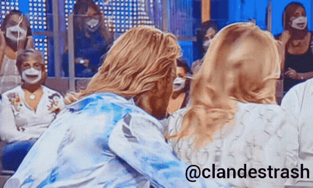 a group of people wearing face masks are sitting in front of a blue background with the hashtag @clandestrash