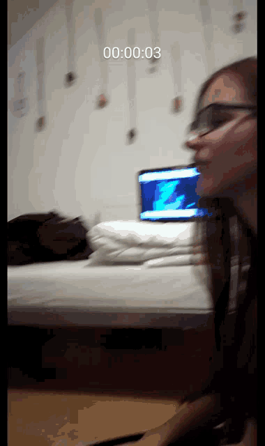 a blurred image of a person with the time 00 : 00 : 03 on the bottom