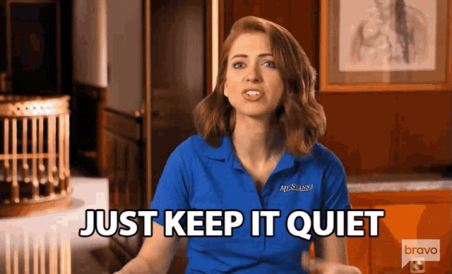 a woman in a blue shirt with the words just keep it quiet