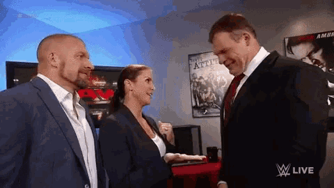 a man in a suit and tie is talking to a woman in a suit .