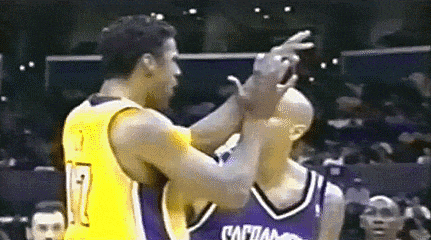 two basketball players are standing next to each other on the court .