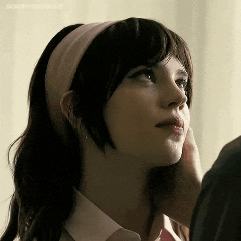 a woman wearing a pink headband is being touched by a man ..
