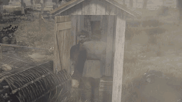 a man in a top hat is standing in front of a outhouse
