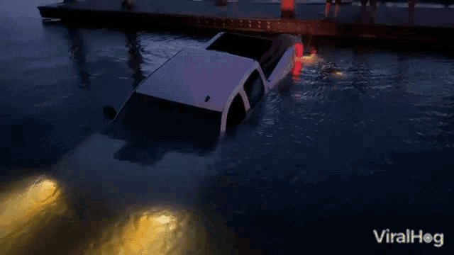 a white truck is submerged in a body of water with viralhog written on the bottom of the image