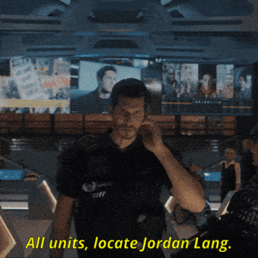 a man in a police uniform talks on a cell phone with the words all units locate jordan lang above him
