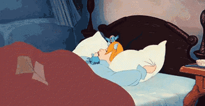 a cartoon of cinderella sleeping in a bed with a stuffed animal on her pillow .