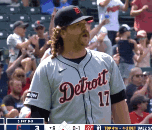 a man in a detroit jersey stands in front of the crowd