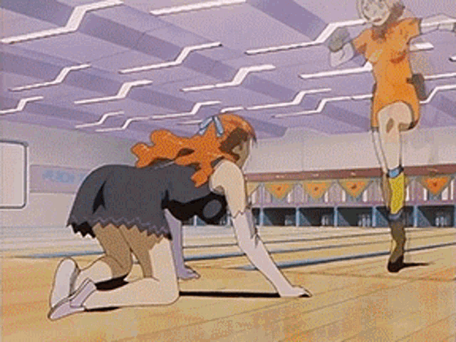 a woman is kneeling down in a bowling alley while another woman runs in the background
