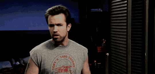 a man wearing a toby 's 1890 tavern t-shirt