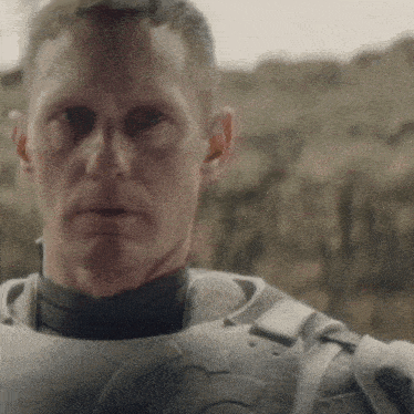 a close up of a man 's face wearing a military uniform