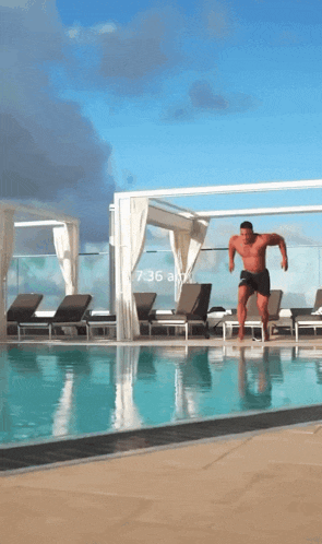 a man is jumping into a swimming pool with a time of 6:36