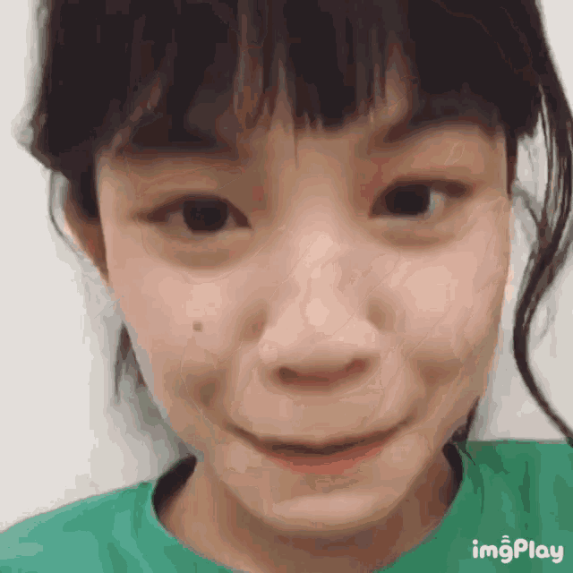 a close up of a girl 's face with the words imgplay visible on the bottom