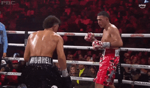 two boxers are fighting in a ring and one has the name morrell on his shorts