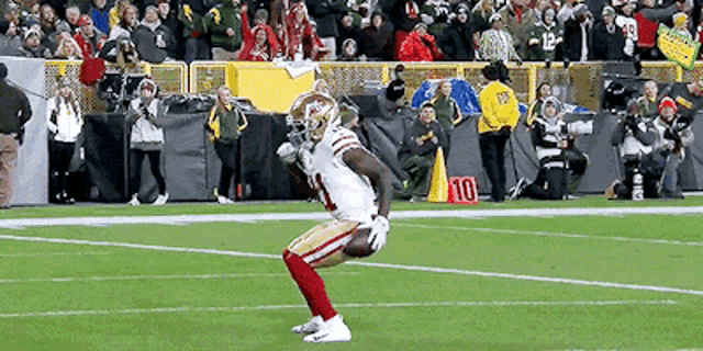 a football player with the number 10 on his jersey is on the field