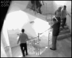 a group of people are walking down stairs in a black and white photo .