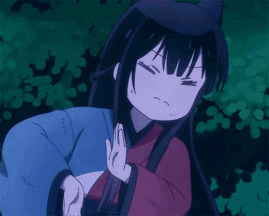 a girl with long black hair is making a funny face with her eyes closed