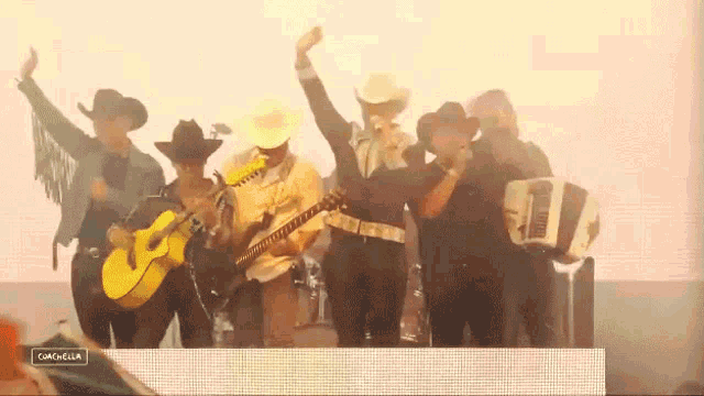 a group of men in cowboy hats are playing instruments and singing in front of a screen that says coachella on it