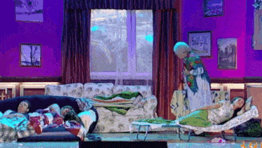 a group of people laying on a couch with a woman standing behind them