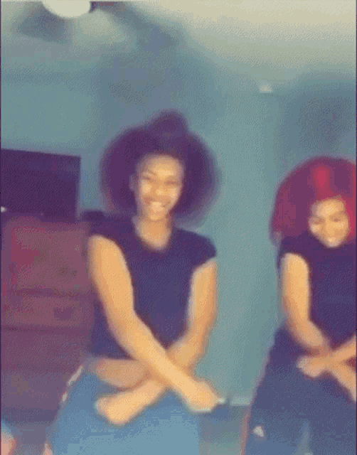 a blurry picture of two women dancing in a room
