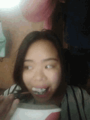 a woman with braces on her teeth is smiling and looking down
