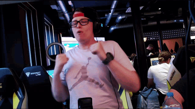 a man wearing headphones and a t-shirt that says secret lab on it