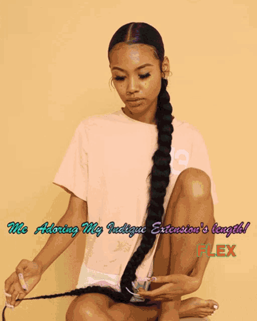 a woman with a very long braided ponytail is wearing a pink shirt that says adidas